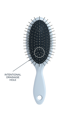 Mini Detangling Brush clipped to bag for travel